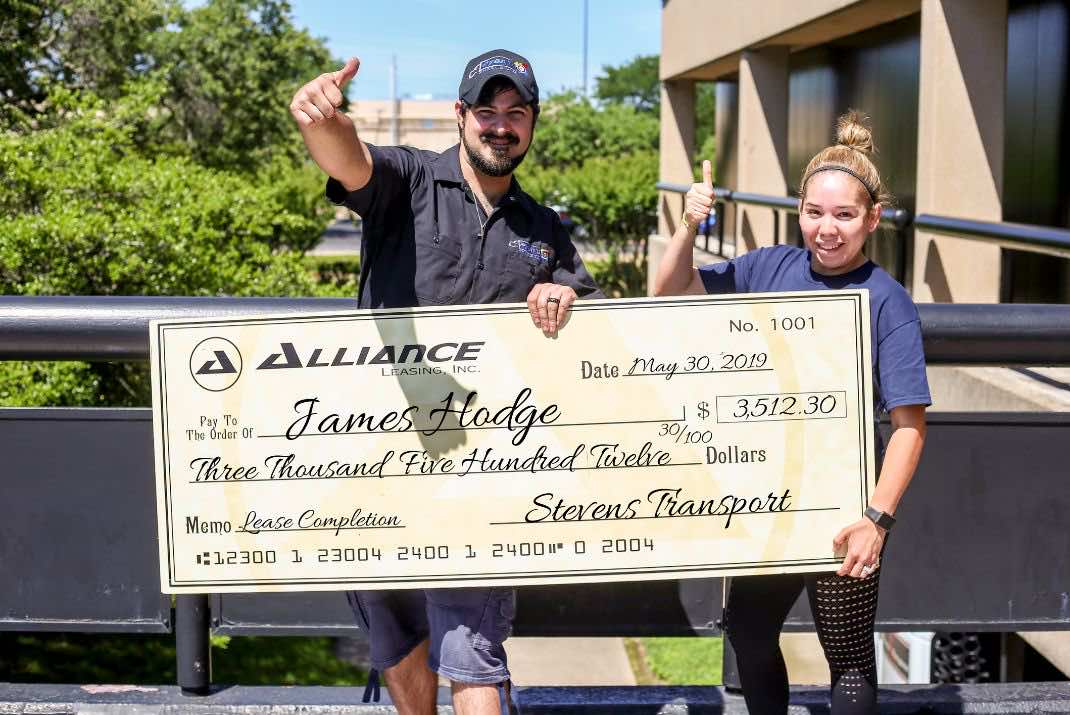 Image of James Hodge and woman with large check