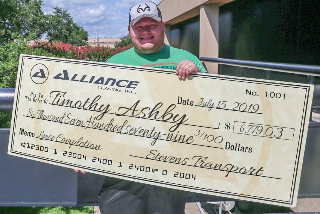 image of Timothy Ashby with lease completion bonus check