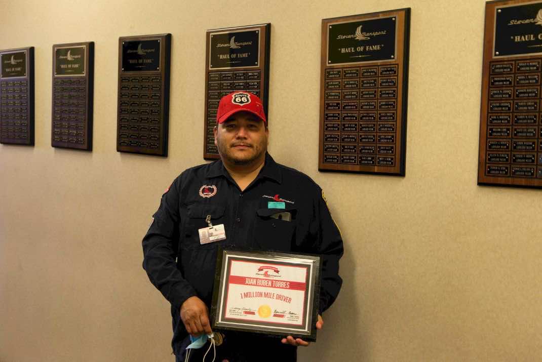 Image of Juan Torres with one million mile award