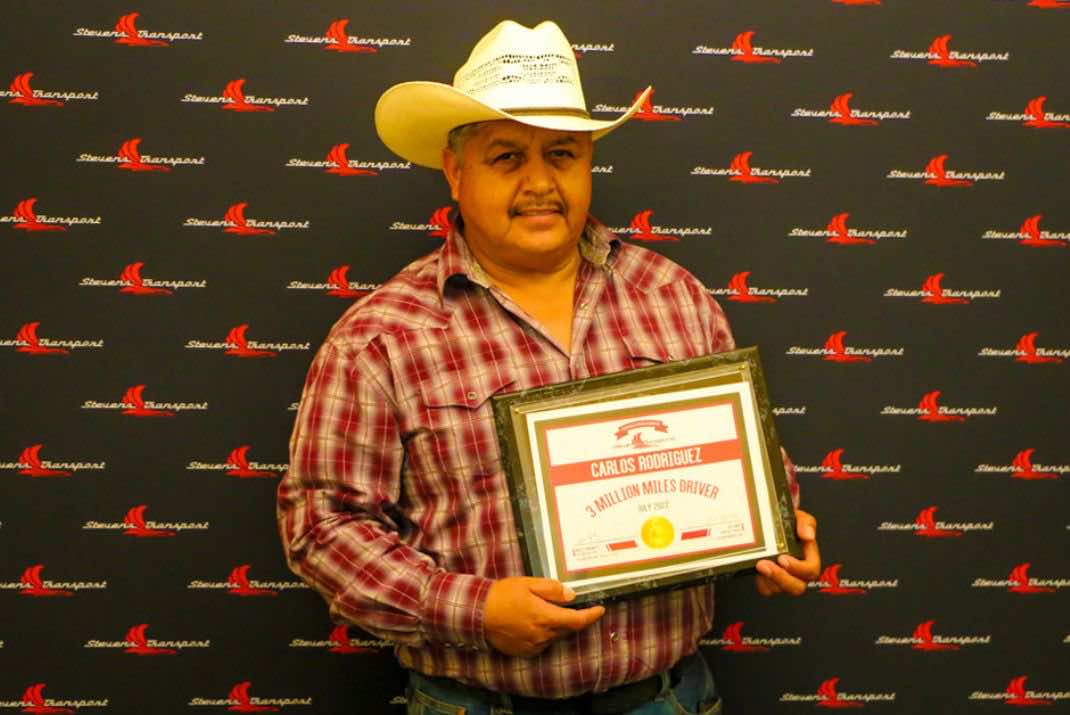 Image of Carlos Rodriguez holding 3 million mile award