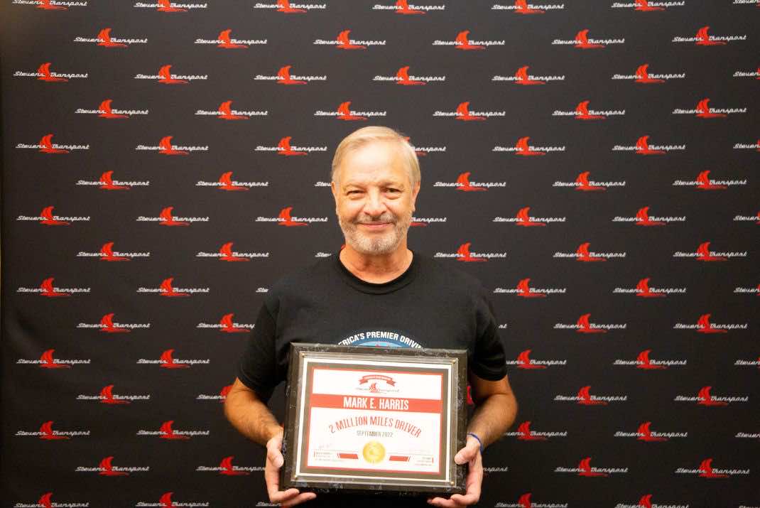Image of Mark Harris holding 2 million mile award