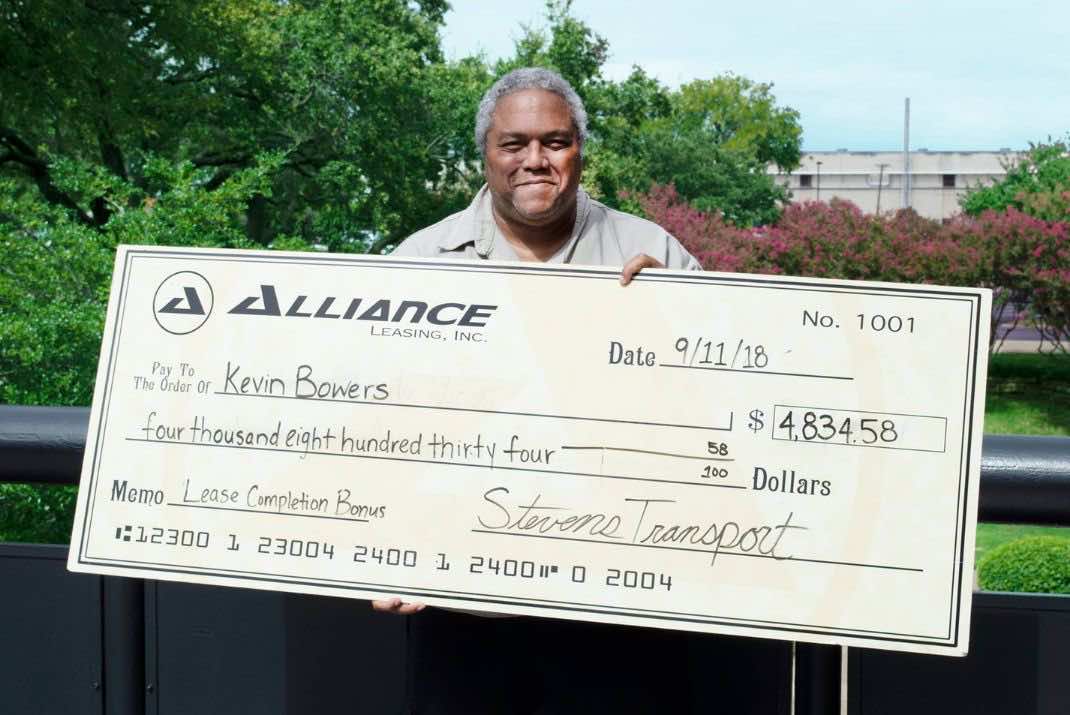 Image of Kevin Bowers holding large check