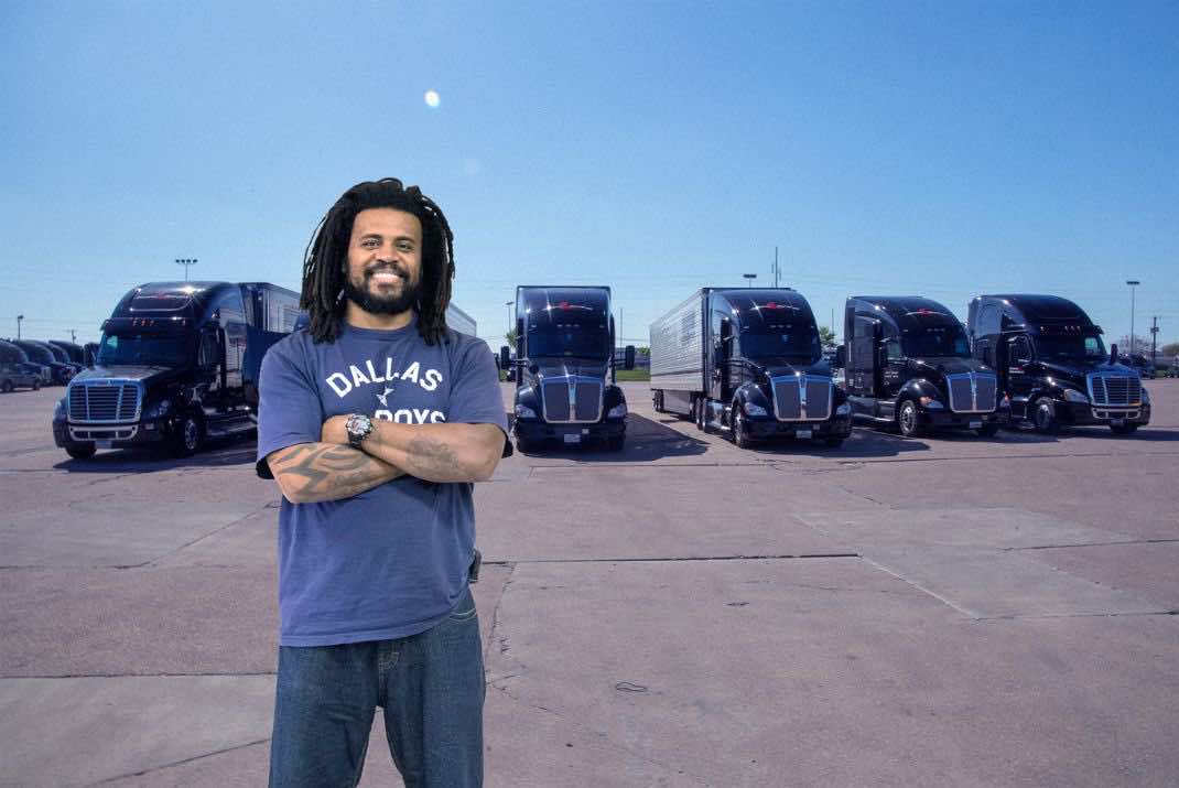 Image of David Roger with his arms crossed standing in front of Stevens trucks
