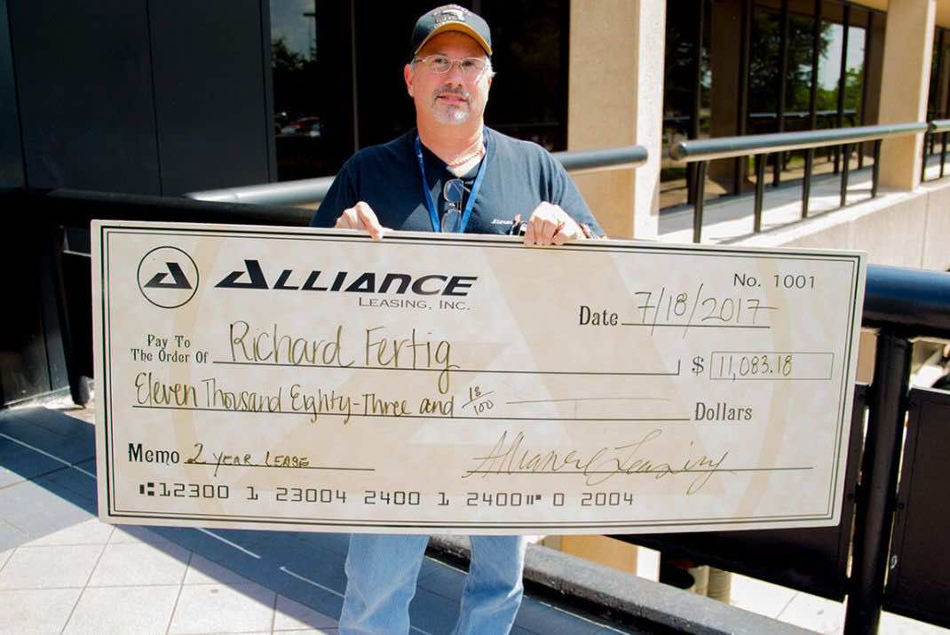 Image of Richard Fertig holding large check