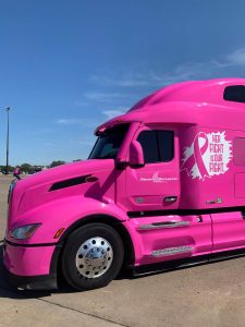Image of pink, breast cancer awareness branded truck with the words "her fight is our fight"