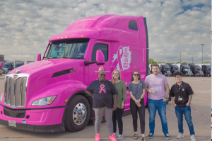 Image of pink, breast cancer awareness branded truck and Stevens team standing in front. From left to right: Nikeyta “Pinky” Matthews, Wendy Jones (Team Lead), Megan Wood (Fleet Manager), Nate Wilson (Planner), Jake Ly (Fleet Manager)