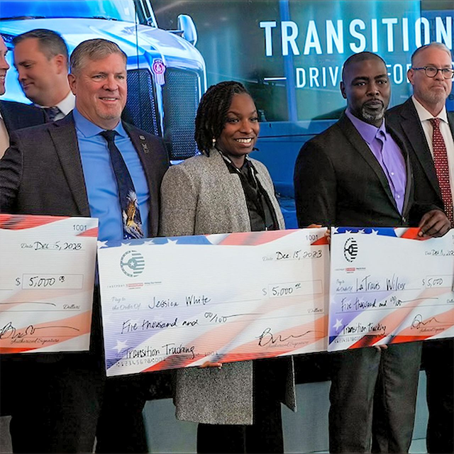 image of Jessica White holding 3rd place prize check for Transition Trucking award