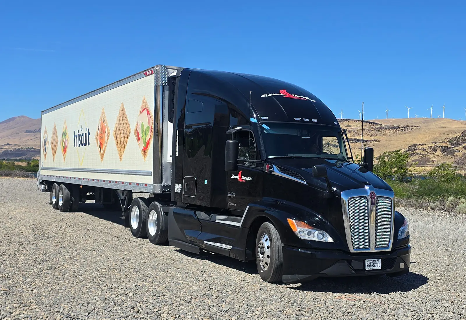 Stevens Transport semi truck with a dedicated Triscuit trailer on gravel road