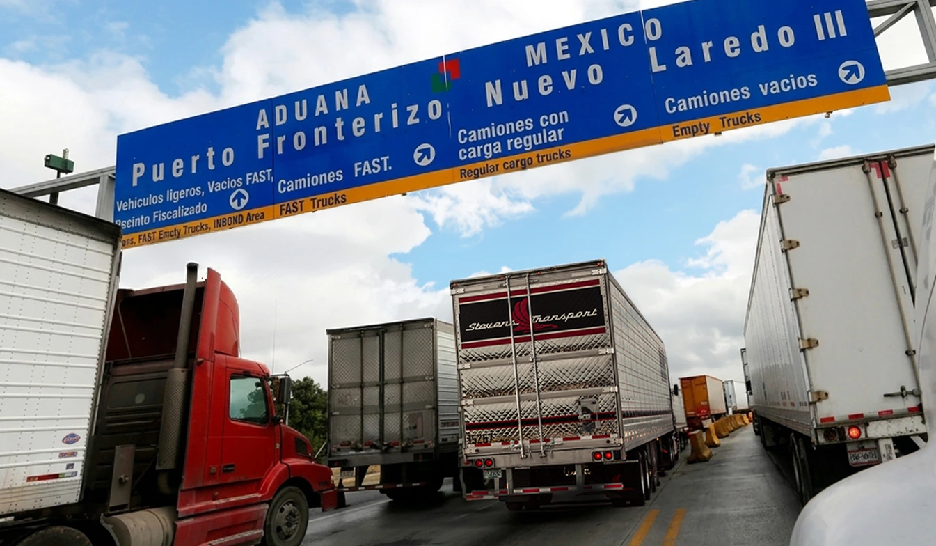 Stevens Transport semi truck and other semis crossing Laredo bridge